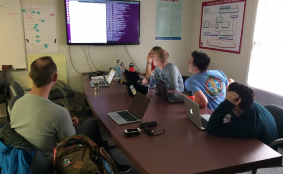 Picture of a group of students in the Capstone Team discussing code 2017 image