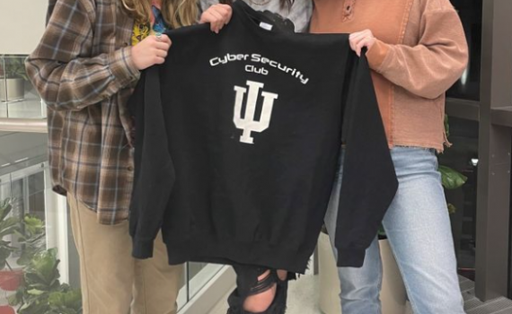 Group of students from IU Cyber Security Club holding a hoodie